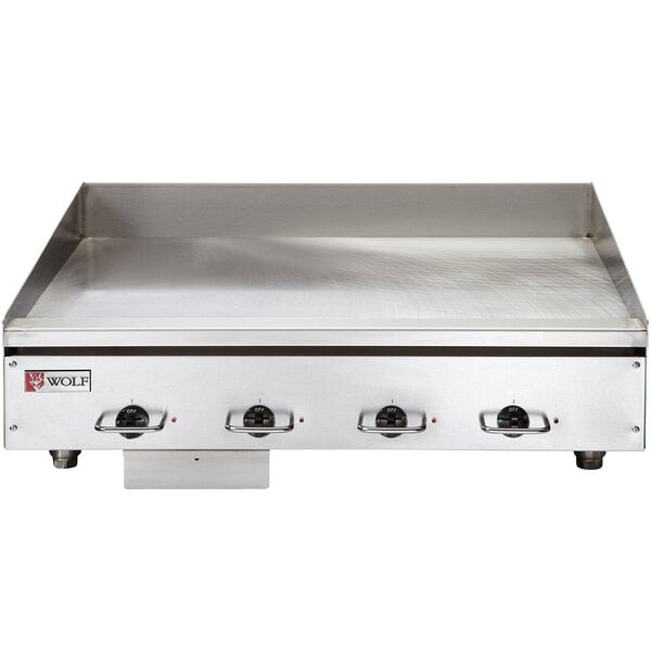 A Wolf stainless steel countertop electric griddle with chrome plate.