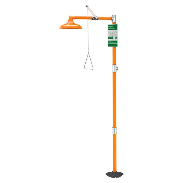 A white free-standing emergency shower with an orange pole and green plastic head.