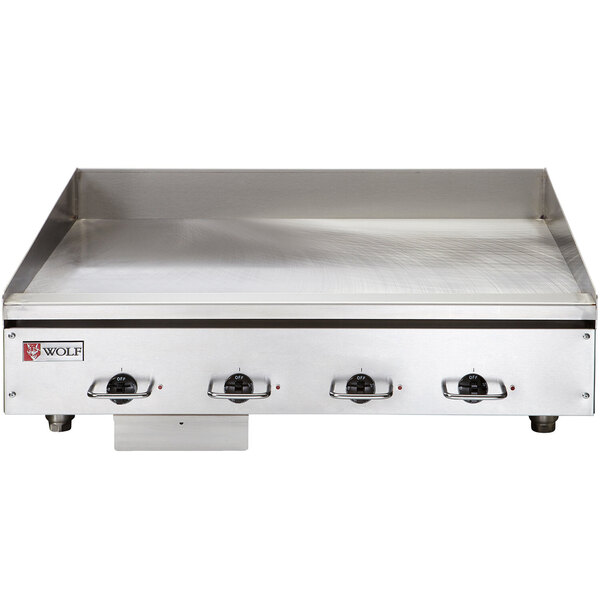 A Wolf stainless steel electric countertop griddle with chrome plate.