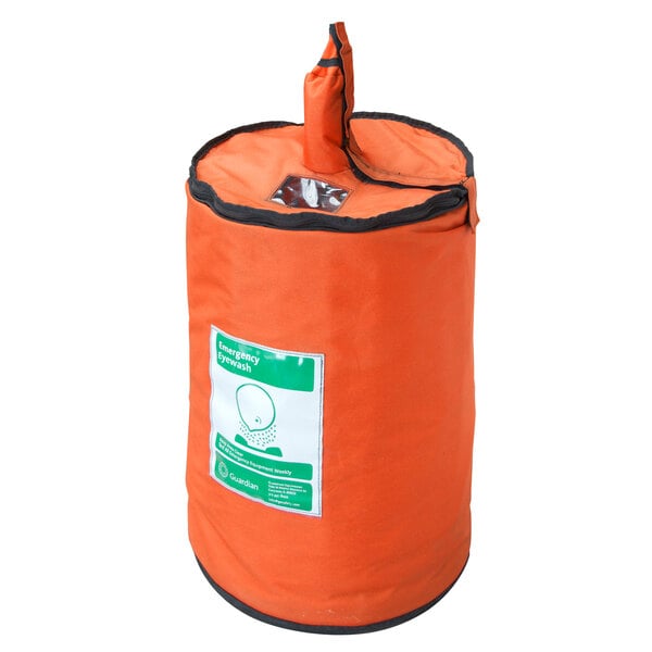 An orange insulated nylon jacket with a green label for a Guardian Equipment portable eyewash station.