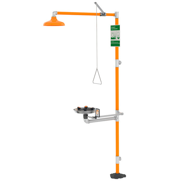A yellow and orange Guardian Equipment barrier-free safety station with a stainless steel cover and wide-area eye and face wash.