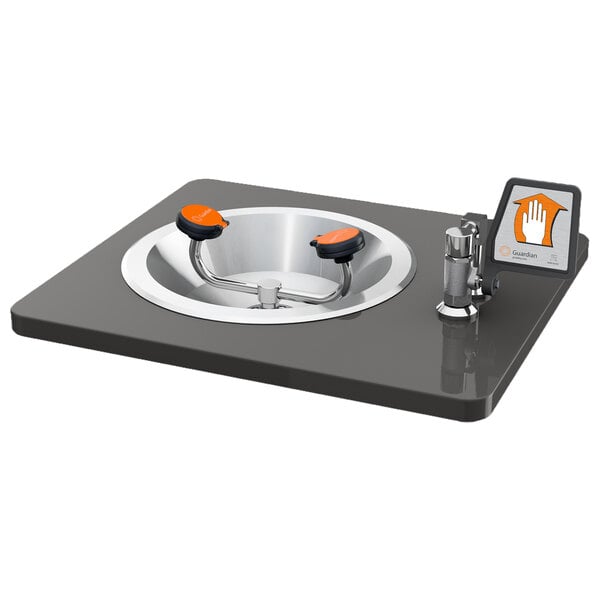 A Guardian Equipment recessed eye and face wash station with a stainless steel bowl and flag handle.