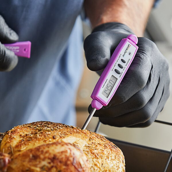 A person in gloves using a purple and white AvaTemp digital pocket probe thermometer to measure the temperature of food.