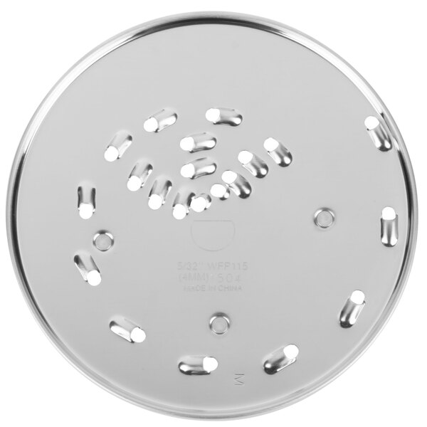 A Waring grating and shredding disc, a circular metal plate with holes.
