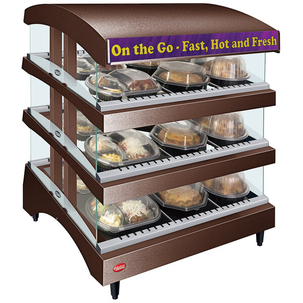 A Hatco Copper Glo-Ray heated food display case with food trays on a display.