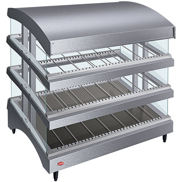 A Hatco countertop heated display warmer with three slanted glass shelves.