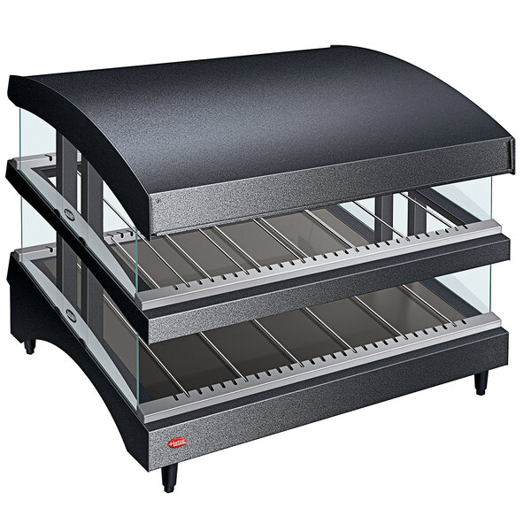 A black Hatco countertop food warmer with curved glass shelves.