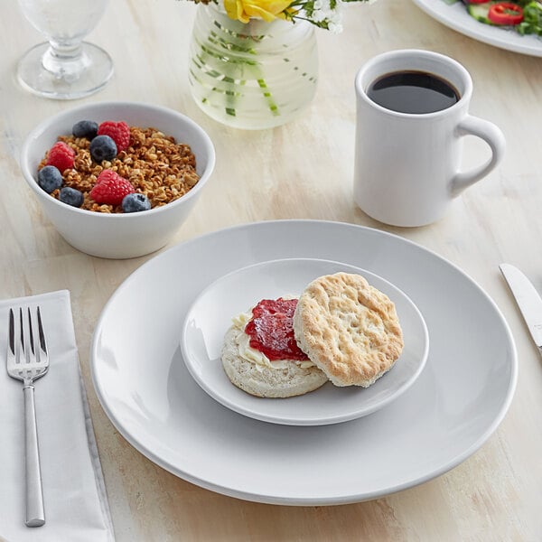 A plate of food with a biscuit and a cup of coffee on white Acopa Bright White dinnerware.