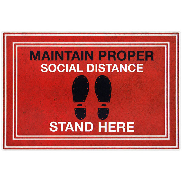A red surface with black text and footprints that says "Maintain proper social distance"