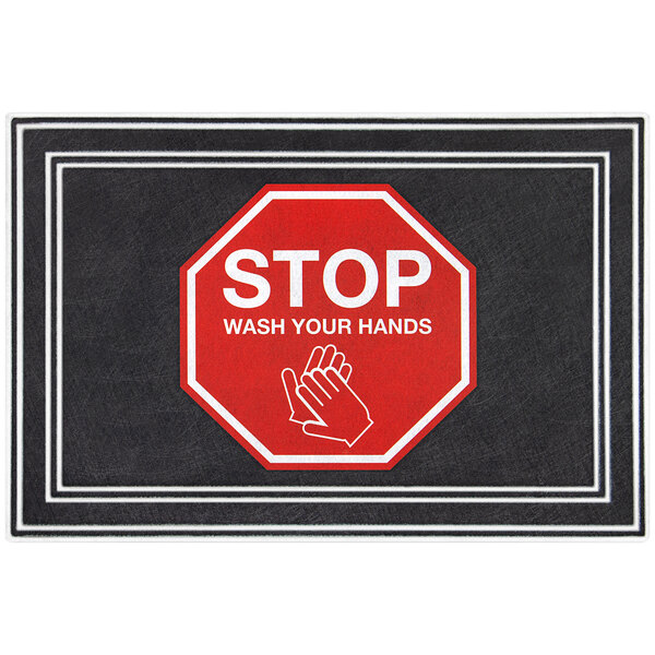 A black Lavex entrance mat with a red stop sign and white text reading "wash your hands" above white handprints.