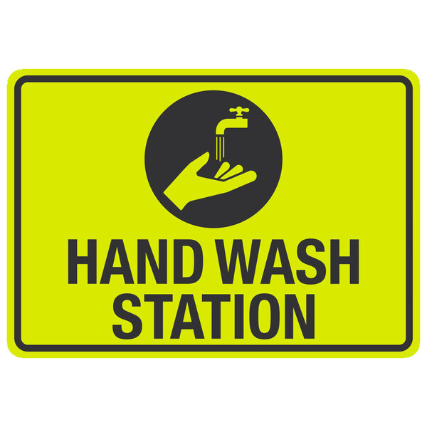 A yellow and black aluminum sign with a hand and a faucet and the words "Hand Wash Station"