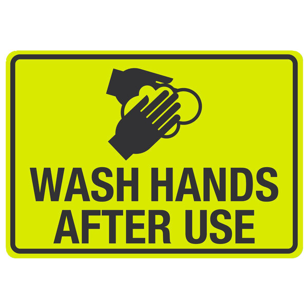 A yellow sign with black text and a hand washing symbol that says "Wash Hands After Use"