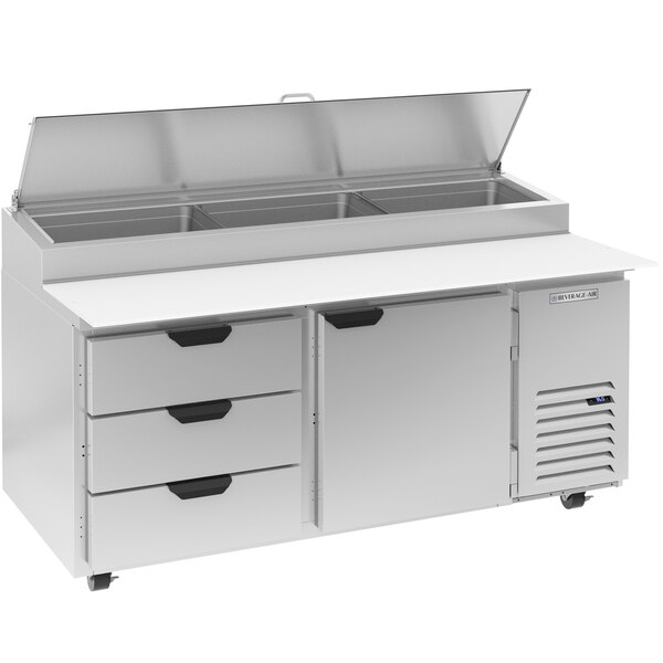 A Beverage-Air stainless steel refrigerated pizza prep table with 3 drawers and a clear lid.