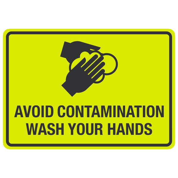 A yellow sign with black text reading "Avoid Contamination / Wash Your Hands" and symbols of hands washing.