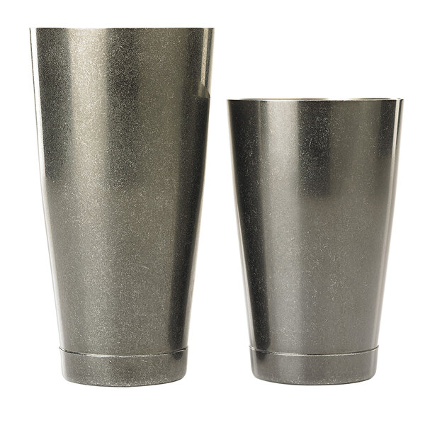 Two metal Boston cocktail shaker cups, one vintage black and one silver, on a white background.