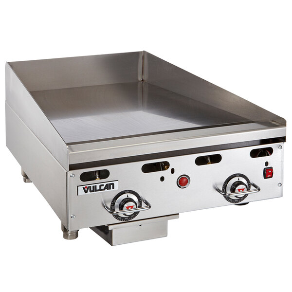 A Vulcan stainless steel commercial griddle with red knobs.