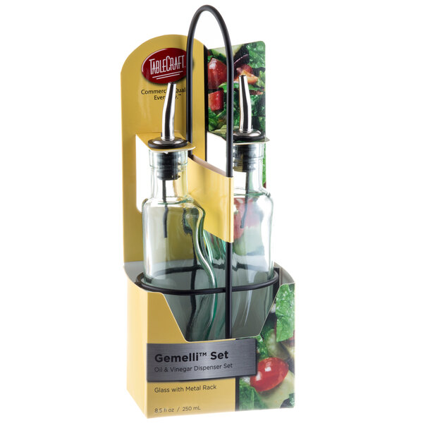 A Tablecraft green tinted glass oil and vinegar cruet set with black rack holding two glass bottles with labels.