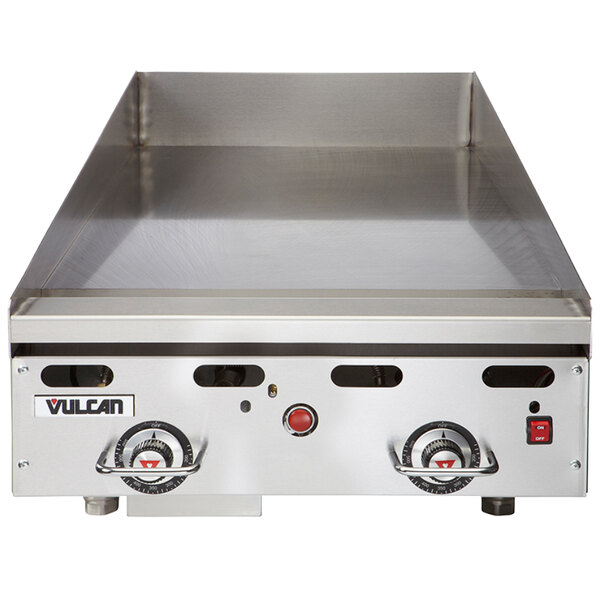 A Vulcan commercial gas griddle with a chrome top on a counter.