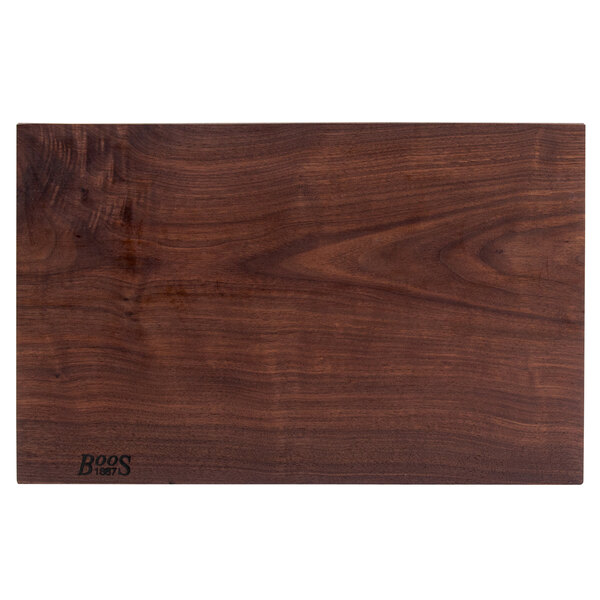 A John Boos black walnut wood cutting board with a rustic edge and company logo.