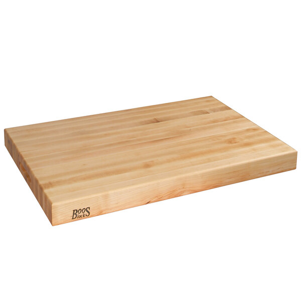 A John Boos maple wood cutting board with hand grips and a logo.