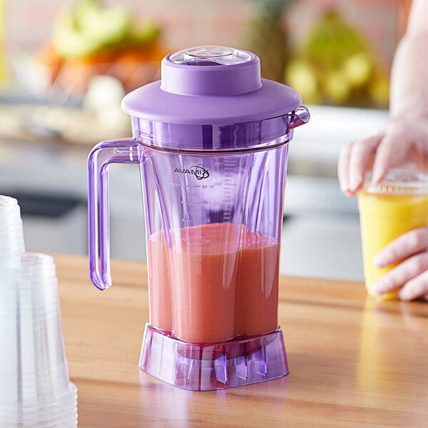 A purple AvaMix blender with a purple Tritan plastic jar filled with pink liquid.