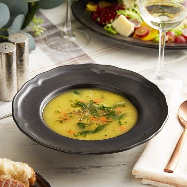 A bowl of soup and a glass of wine on a table in a farm-to-table restaurant.