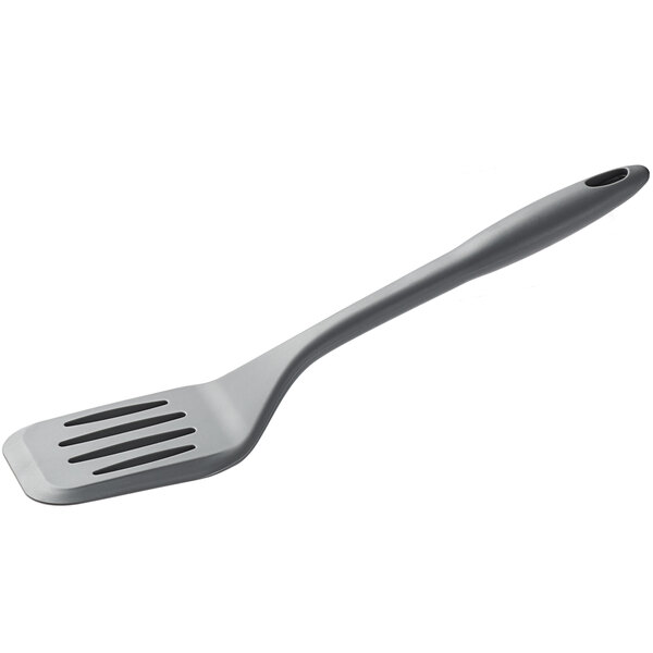 A Tablecraft gray flexible slotted turner with a handle.