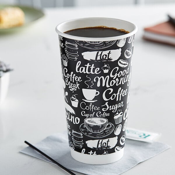 A black and white Choice paper hot cup filled with coffee on a napkin.