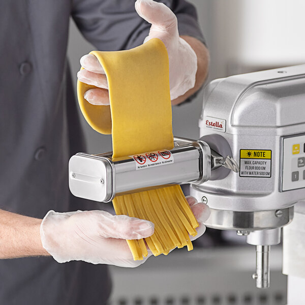 A person using the Estella pasta roller and cutter attachment kit on a mixer.