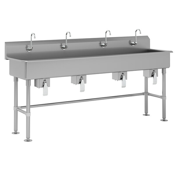 An Advance Tabco stainless steel utility sink with four knee valve faucets.