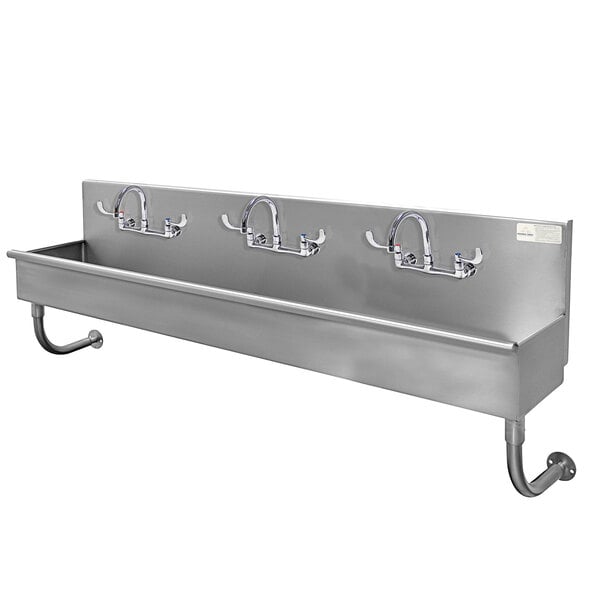 A stainless steel Advance Tabco wall mounted hand sink with 3 faucets.