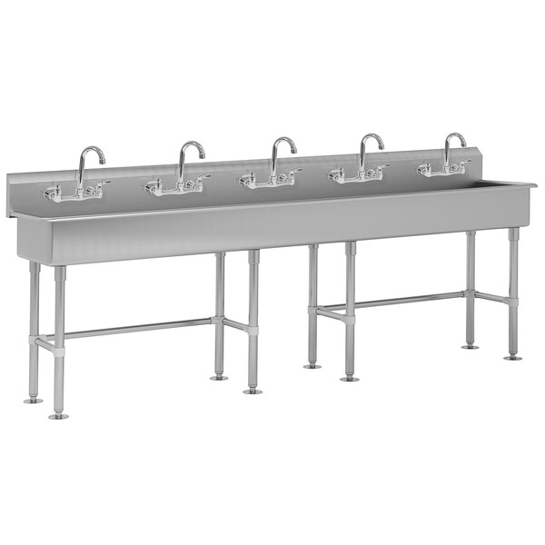 A large stainless steel Advance Tabco multi-station hand sink with three sinks and five faucets.