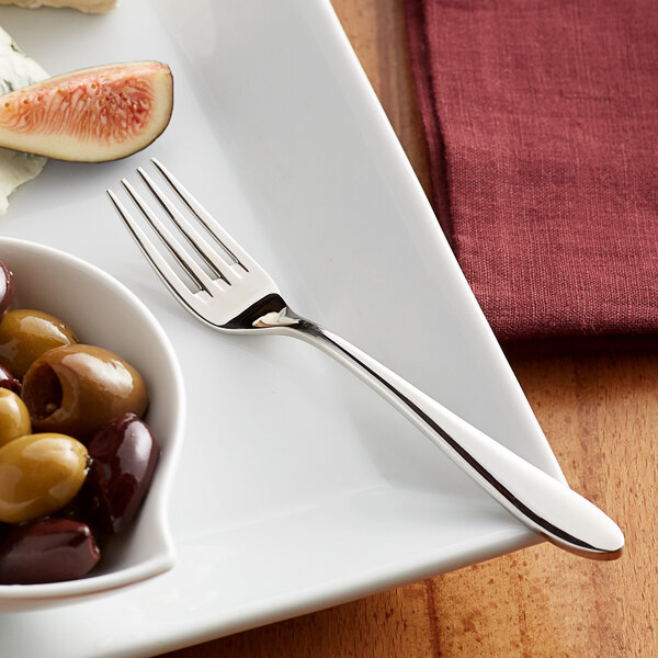 An Acopa Remy stainless steel cocktail/oyster fork on a plate of olives, cheese, and bread.