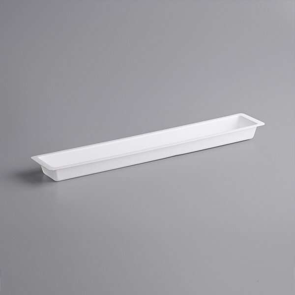 A white rectangular container with a long handle.