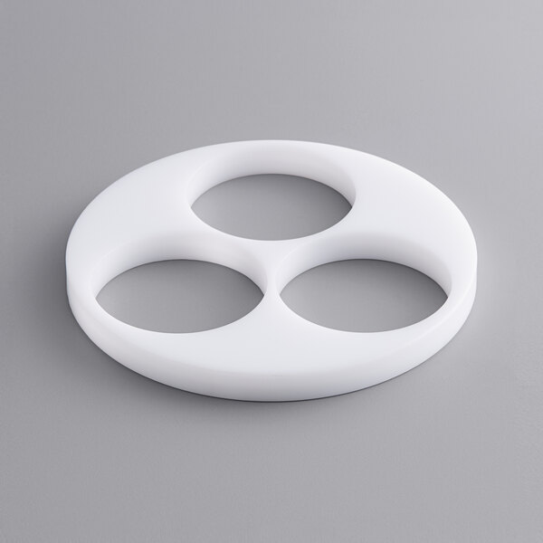 A white circle shaped object with three smaller circles inside.