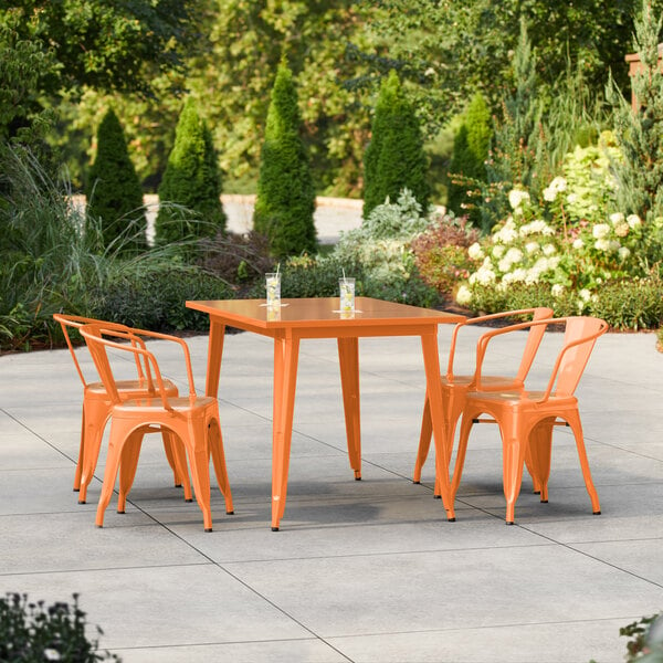 Lancaster Table & Seating Alloy Series 47 1/2" x 29 1/2" Amber Orange Standard Height Outdoor Table with 4 Arm Chairs