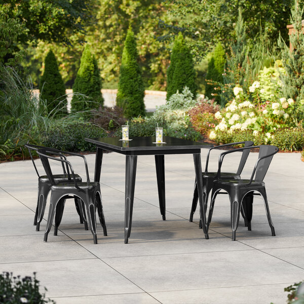 Lancaster Table & Seating Alloy Series 47 1/2" x 29 1/2" Distressed Onyx Black Standard Height Outdoor Table with 4 Arm Chairs