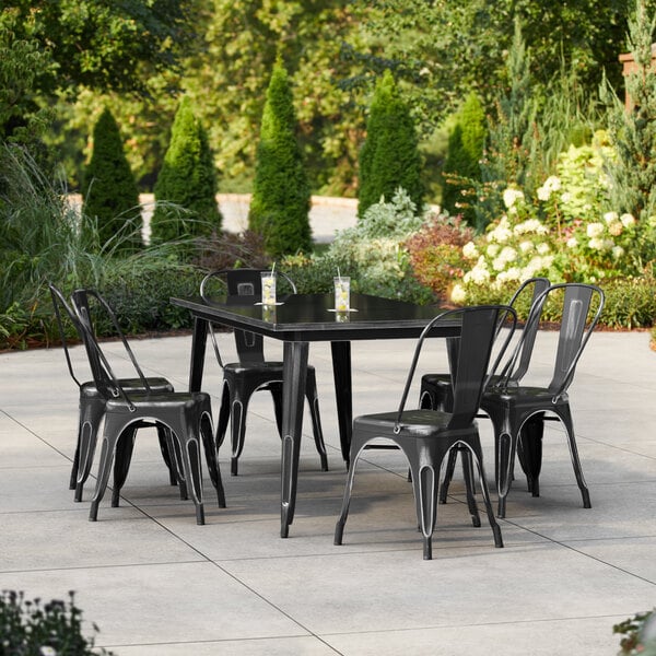 Lancaster Table & Seating Alloy Series 63" x 31 1/2" Distressed Black Standard Height Outdoor Table with 6 Cafe Chairs