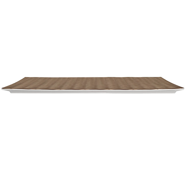 A rectangular white melamine platter with a brown textured surface on a table.