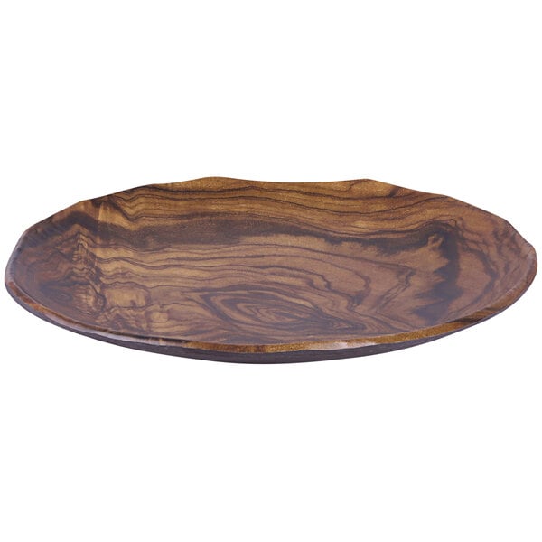 An Elite Global Solutions Sequoia wood grain melamine plate with a wavy edge on a table.