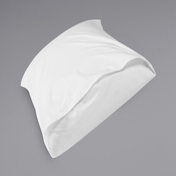 A white Protect-A-Bed waterproof pillow on a bed.