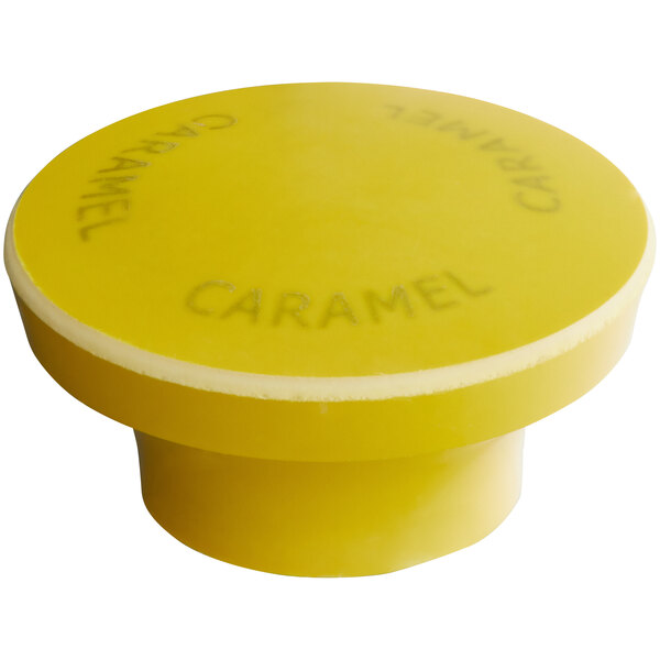A yellow plastic knob with the word "Caramel" on it.
