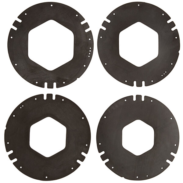 A group of four black circular gaskets with holes in them.