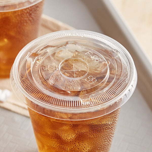 A plastic cup with a clear EcoChoice PLA compostable plastic lid and a drink.