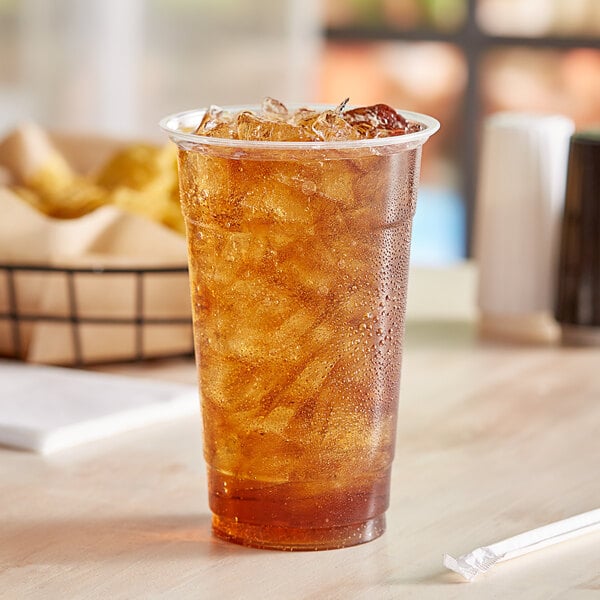 A EcoChoice PLA compostable plastic cup of ice tea with a straw.
