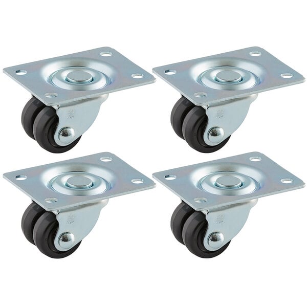 A set of four True metal swivel plate casters with black rubber wheels.