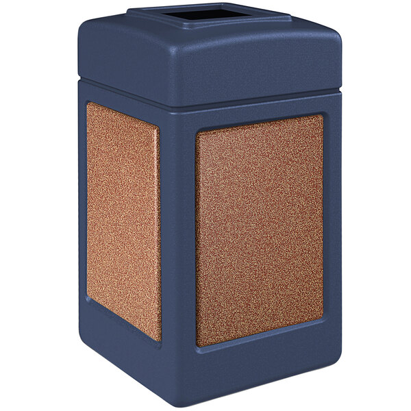 A blue rectangular Commercial Zone StoneTec waste receptacle with square lid decorated with brown Sedona panels.