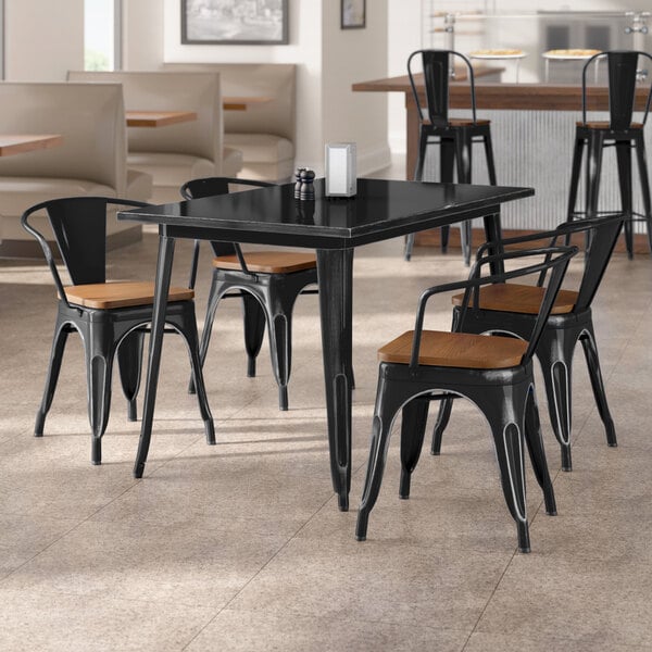 Lancaster Table & Seating Alloy Series 30" x 48" Distressed Black Standard Height Indoor Table and 4 Arm Chairs with Walnut Wood Seats