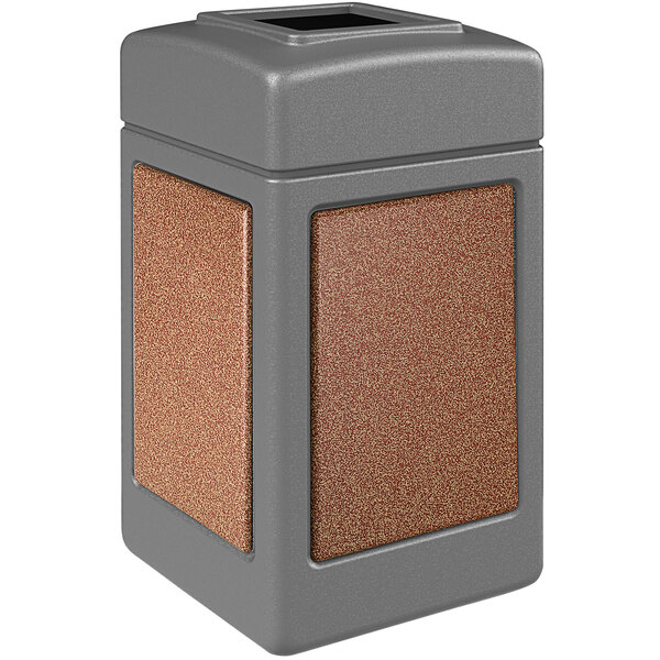 A gray StoneTec waste receptacle with Sedona panels on the sides and a square lid.
