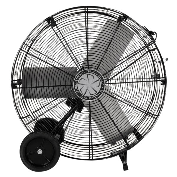 A large black TPI industrial drum fan with wheels.